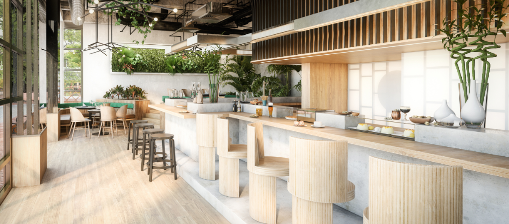 Interior de un local de hostelería con barra de madera, taburetes y plantas colgantes